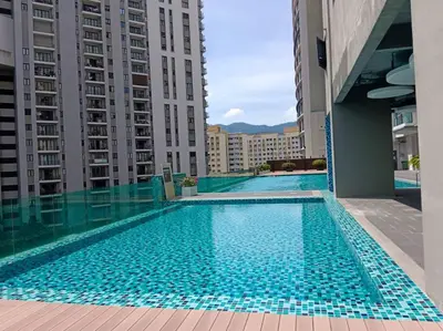 a swimming pool in a building with tall buildings at JazzA 2R3B Suite Strait Quay Near Stonyhurst School by Homey Planet in Tanjong Tokong