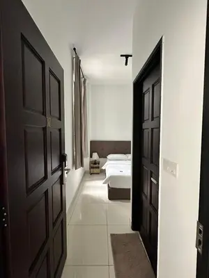 an open door to a bedroom with a bed at Lodge 43 House in George Town