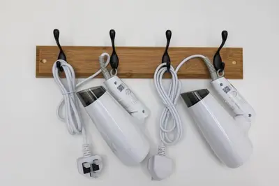 four wii controllers are hanging on a wall at Urban Suites with Spectacular High Floor View #3BR #03 in Jelutong