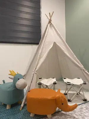 a teepee tent with a toy cow and chairs at IPOH LYL EVERGREEN HOMESTAY 12pax in Ipoh