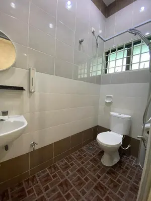 a bathroom with a toilet and a sink at IPOH LYL EVERGREEN HOMESTAY 12pax in Ipoh