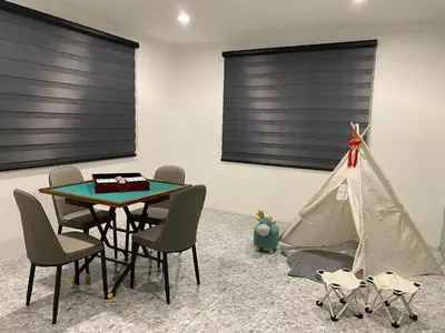 a dining room with a tent and a table and chairs at IPOH LYL EVERGREEN HOMESTAY 12pax in Ipoh