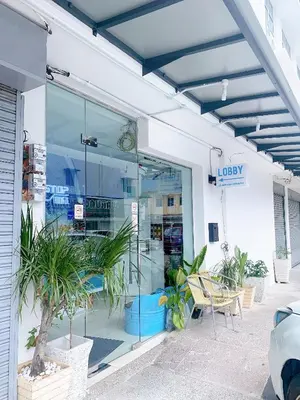 a store front with glass doors and potted plants at One Stop Hotel Ipoh in Ipoh