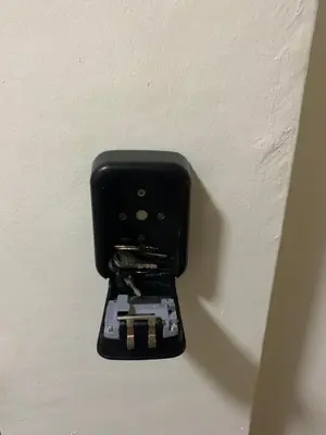 a black electrical outlet on a white wall at HappyHomestay in Brinchang