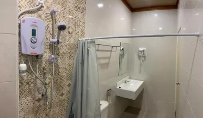 a bathroom with a shower and a sink at HappyHomestay in Brinchang