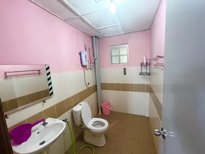 a pink bathroom with a toilet and a sink at Zurie Muslim Homestay in Brinchang