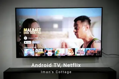 a flat screen tv sitting on top of a shelf at Iman Cottage Homestay Hospital Kulim Hitech in Kulim