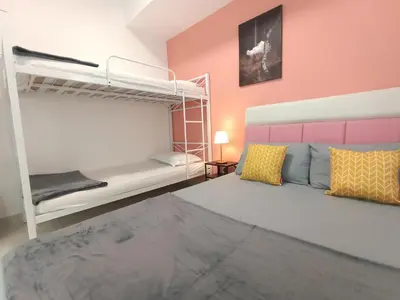 a bedroom with two bunk beds in a room at Maritime Suite @ George town by Cohans in Jelutong