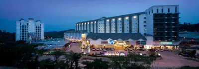 a large building with a courtyard in front of it at Nova Highlands Hotel in Cameron Highlands