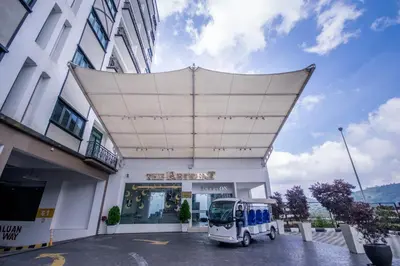 a white truck parked in front of a building at Nova Highlands Hotel in Cameron Highlands