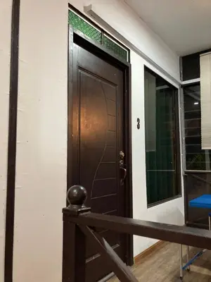 a wooden door in a room with a window at Rods Homestay - Kg Agong Penaga in Kepala Batas