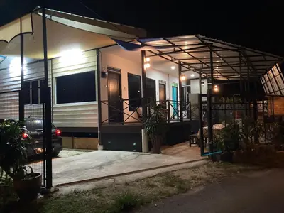 a house with a car parked in front of it at night at Rods Homestay - Kg Agong Penaga in Kepala Batas