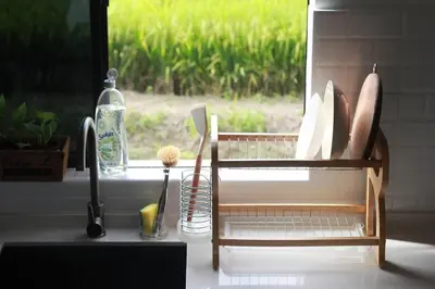 a kitchen counter with a window and a sink at Mai Paddy Cottage, Balik Pulau in Balik Pulau