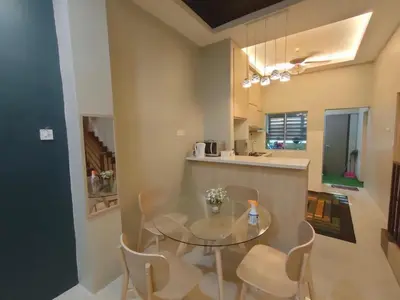 a dining room with a glass table and chairs at Homestay Gerik Le rizq Homestay~ Heart of Gerik ~ Cozy in Gerik