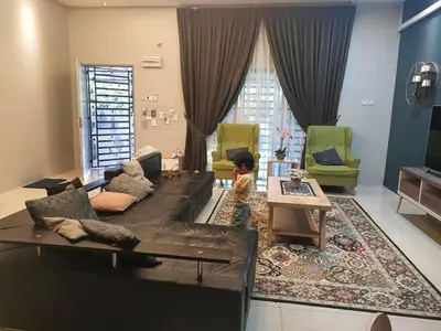 a living room with a couch and a child sitting on a rug at Homestay Gerik Le rizq Homestay~ Heart of Gerik ~ Cozy in Gerik