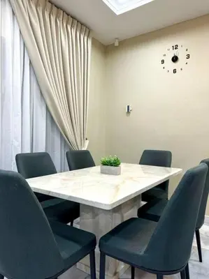 a conference room with a table with chairs and a clock at YK Sweet home sungai petani 1 @ 16 people above in Sungai Petani