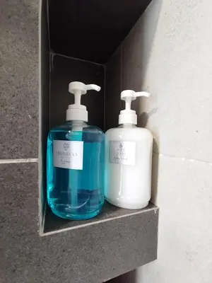 two bottles of soap are sitting in a box at Seaview Infinity Pool , 40th , 9pax, 3Rooms 2Carpark in Jelutong