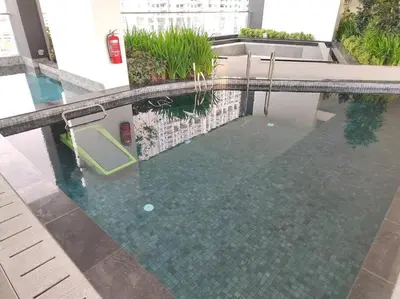 a swimming pool in a building with water in it at Seaview Infinity Pool , 40th , 9pax, 3Rooms 2Carpark in Jelutong