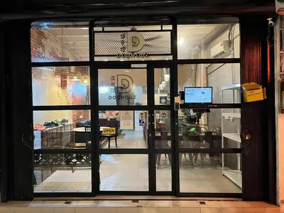 a glass door to a restaurant with a table in it at Dou Houz Georgetown in George Town