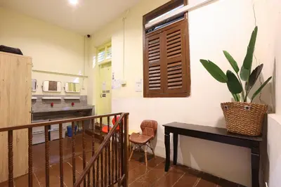 a hallway with a table and a plant on the wall at Dou Houz Georgetown in George Town