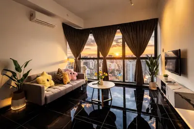 a living room with a couch and a large window at Urban Suites Georgetown l SeaView & CityView l Family Stay in Jelutong