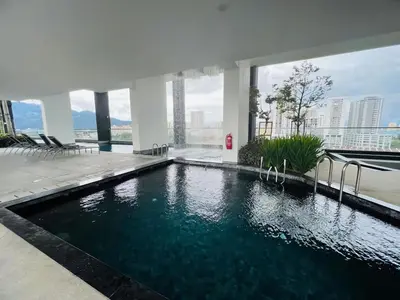 a swimming pool in the middle of a building at Urban Suites Georgetown l SeaView & CityView l Family Stay in Jelutong