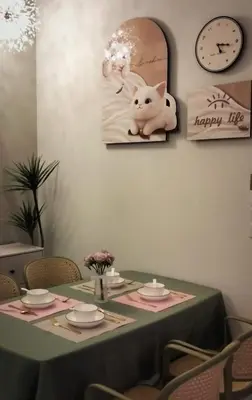a table with a happy life picture and a clock at 
