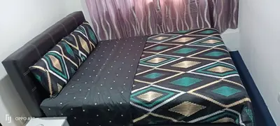 a black couch with a blanket on it at Hotel Blue Orchid in Bayan Lepas