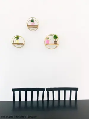 a bench against a white wall with two mirrors at Sunshine Lot 10 Pangkor in Kampong Sungai Udang