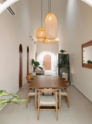a dining room with a wooden table and chairs at Mint Villa with Jacuzzi Pool in George Town