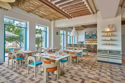 a restaurant with tables and chairs in a room at Marriott Executive Apartments Penang in George Town
