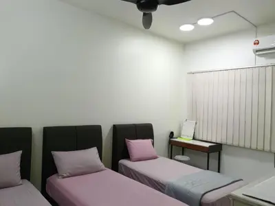 a room with two beds with pink pillows at Cozy Modern Classic Home in Ipoh in Ipoh