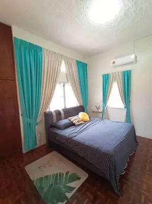a bedroom with a bed with blue curtains and a window at The Hidden 7 in Taiping