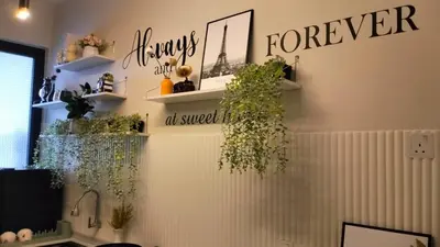 a room with shelves with plants on the wall at Urban Suites 3 Rooms, Cat Theme & Romantic in Jelutong