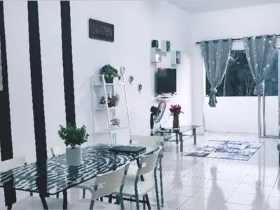a dining room with a glass table and chairs at Barakah Sufi Home Stay Apartment Cameron in Tanah Rata
