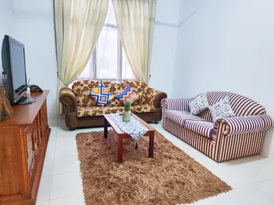 a living room with two couches and a table at IPOH Chemor Casa Klebang, 5 PAX Fully Air-Con Homestay in Chemor