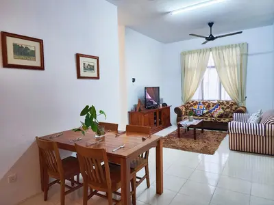 a living room with a wooden table and chairs at IPOH Chemor Casa Klebang, 5 PAX Fully Air-Con Homestay in Chemor