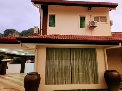 a house with a window with a fan on it at Tambun lost world luxury villa 5BR/20 pax/mahjong/karaok/bbq/garden events in Tambun
