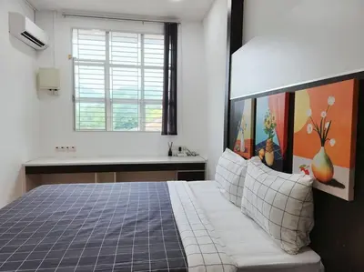 a bedroom with a bed and a sink and a window at Tambun lost world luxury villa 5BR/20 pax/mahjong/karaok/bbq/garden events in Tambun