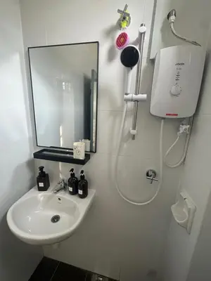 a white bathroom with a sink and a mirror at Pantai Remis Bear Homestay in Pantai Remis