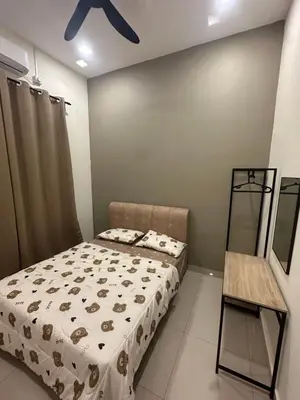 a bedroom with a bed and a ceiling fan at Pantai Remis Bear Homestay in Pantai Remis