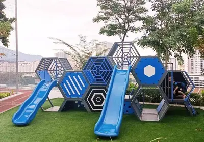 a playground with a blue slide on the grass at Romantic Sea View @ Urban Suite in Jelutong