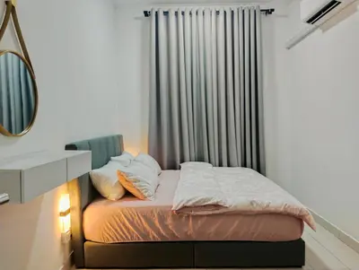 a bedroom with a bed with a mirror and a window at UR Homestay, Seri Iskandar in Seri Iskandar