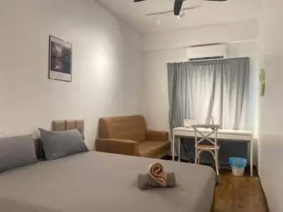 a bedroom with a bed and a chair and a desk at Modern Cozy House 4 ROOM 10pax@Bukit Mertajam in Bukit Mertajam