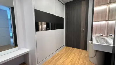 a room with a hallway with a tv and a closet at Grand’e La Villa Homestay in Lumut