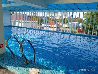 a swimming pool with a view of a building at Seberang Jaya Family Pool Homestay Near Hospital 3 Bedroom Aircond 2 Bathroom & Family Room Aircond in Perai