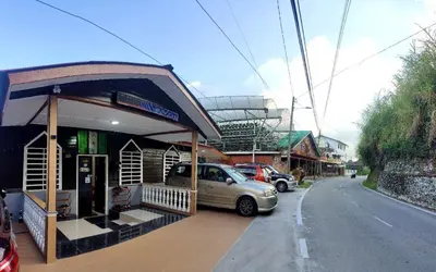 a car parked at a gas station on the side of the road at Santai Desa Chalet musleem 0nly in Brinchang