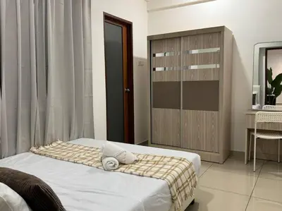 a bedroom with a bed and a wooden cabinet at 【NEW】Harmony’s Home@Juru Sentral Icon City in Bukit Mertajam