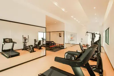 a gym with treadmills and ellipticals in a room at 【NEW】Harmony’s Home@Juru Sentral Icon City in Bukit Mertajam