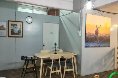 a dining room with a table and a picture of a deer at Kitty Home Near to Penang Hill in Ayer Itam